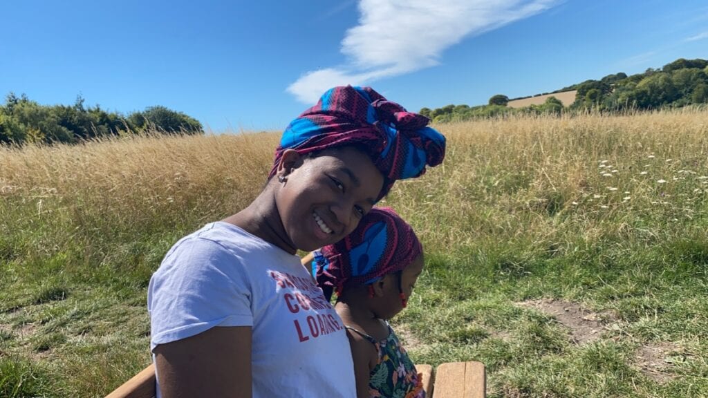 Princess and Rainbow sitting outside smiling. Creating generational wealth with mums Life Insurance policy