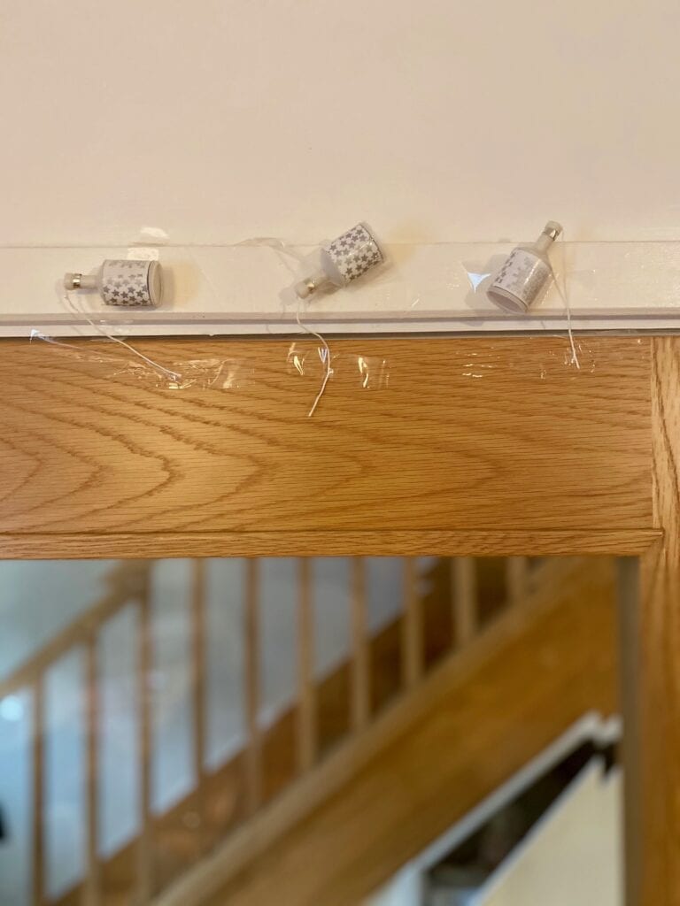 line of poppers taped to a wall